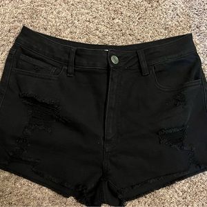 So black jean shorts with ripped look.